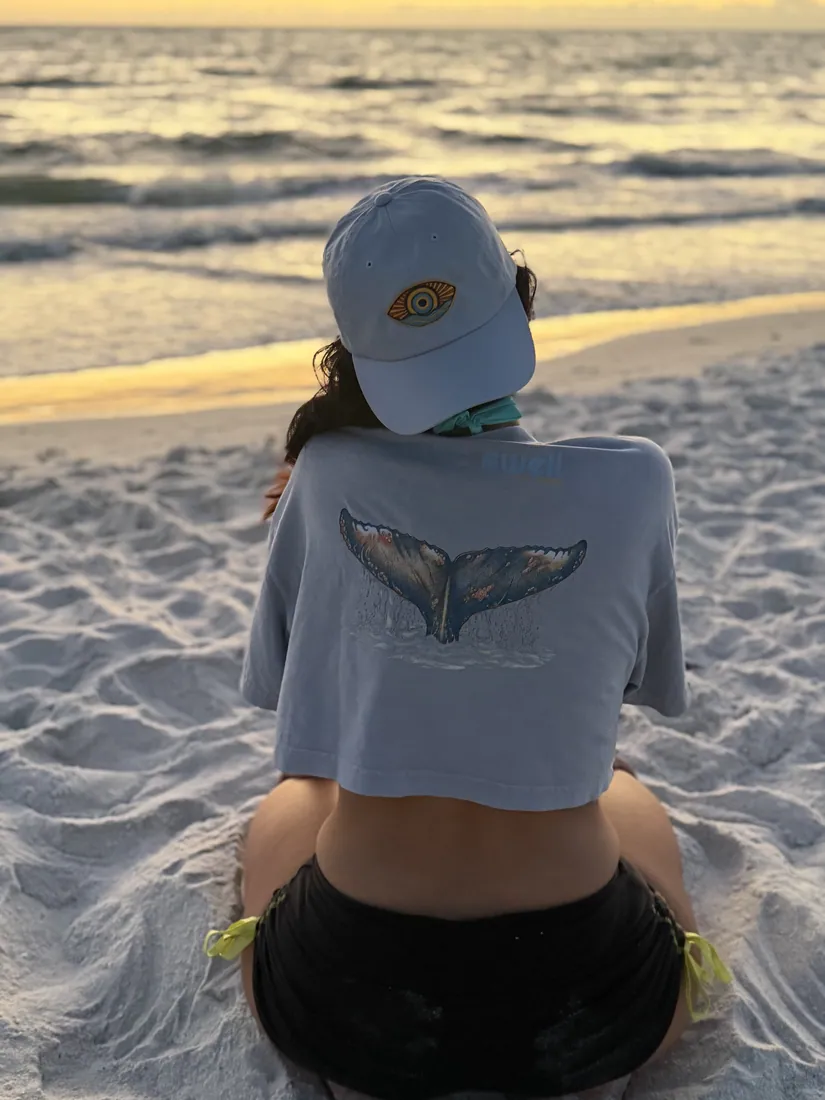 The whale-tail graphic on the beach