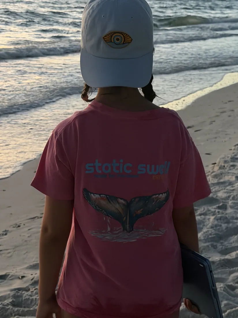 Youth whale-tail tee at the water's edge