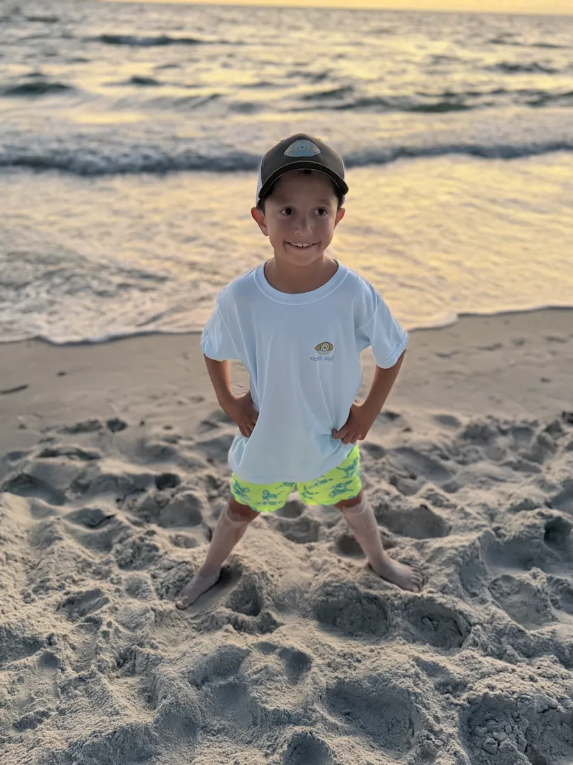 A youth tee on the sand